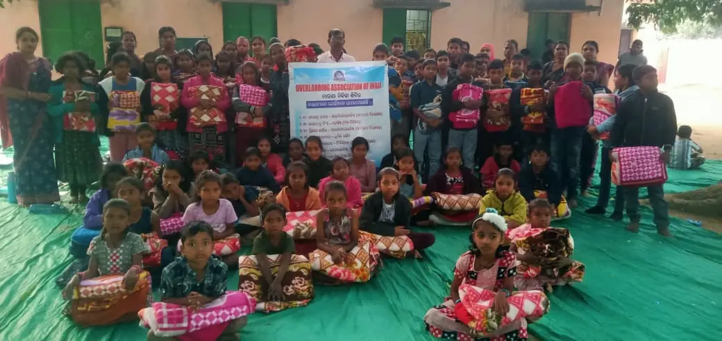 Children holding donated blankets at an OAI winter distribution drive