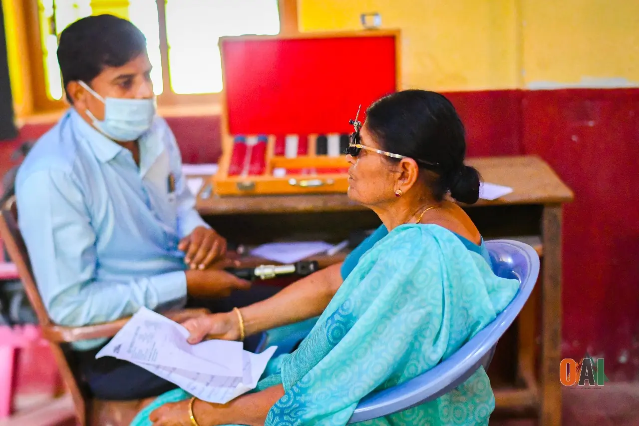 A volunteer conducting an eye examination at an OAI medical camp