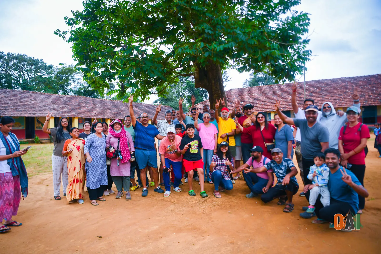OAI members and schoolchildren celebrating together after a stationery drive