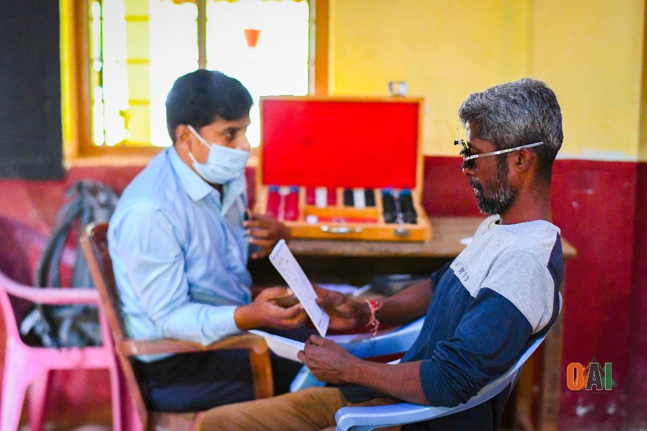 An OAI volunteer conducting a free eye check-up at a rural medical camp