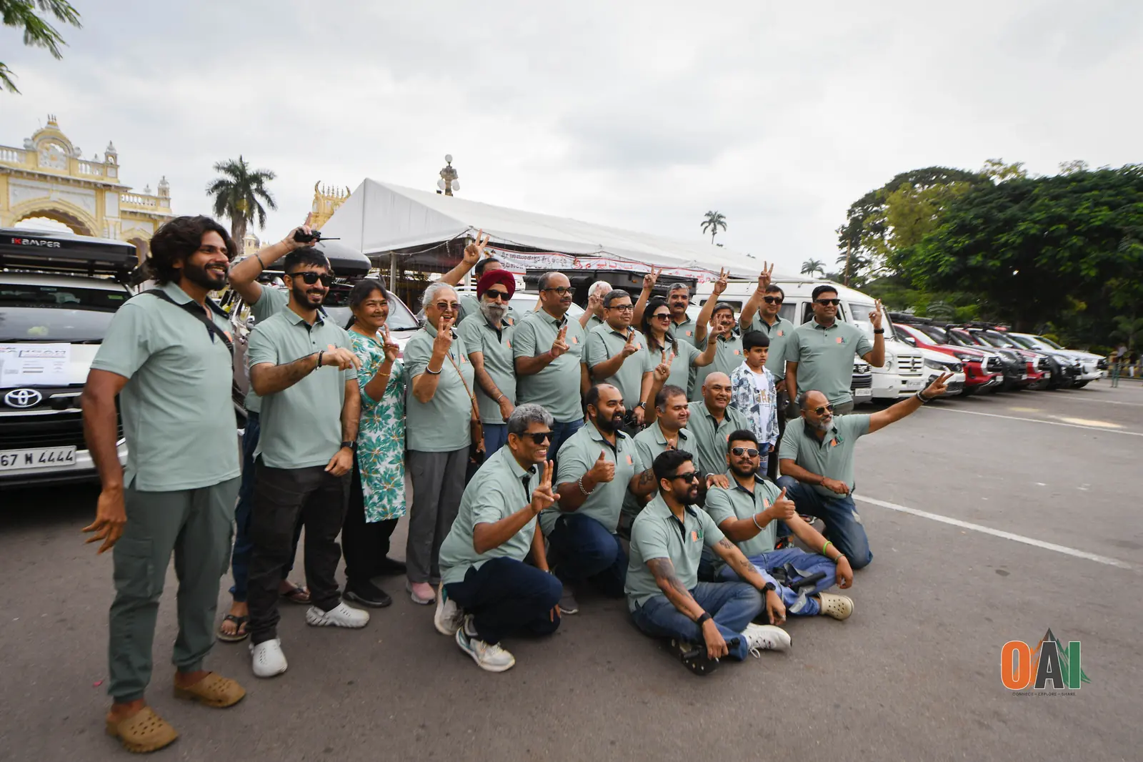OAI members posing together in front of Mysore Palace at Sangam 2024