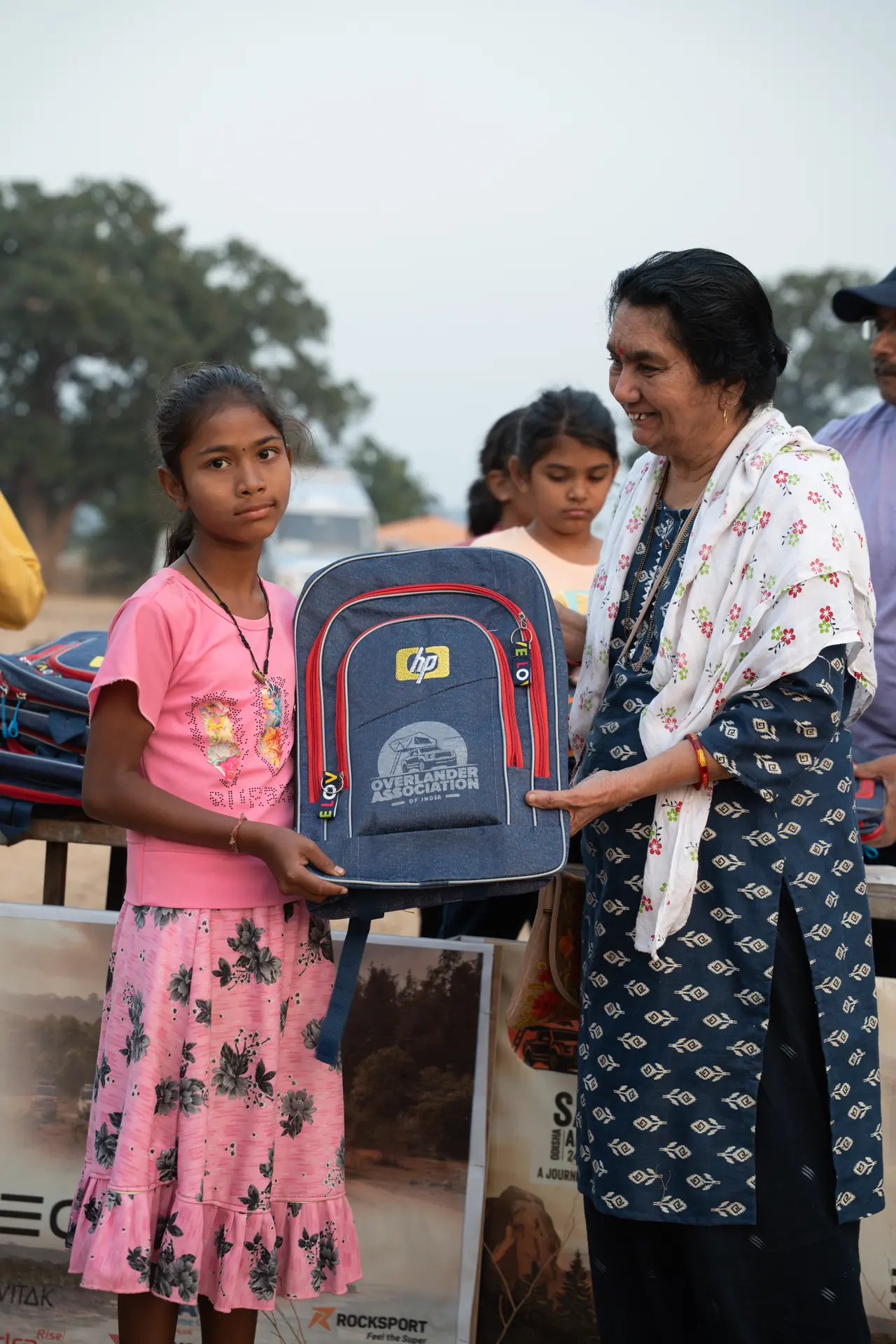 A local student receiving a school backpack at Hirakud